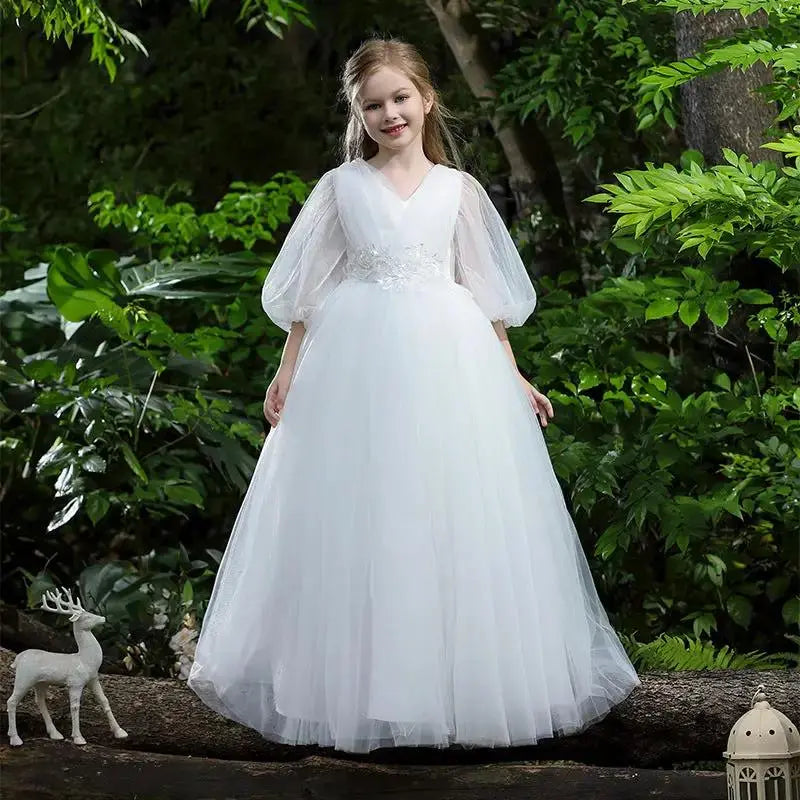 White tulle princess dress featuring puff sleeves and floral embellishments.
