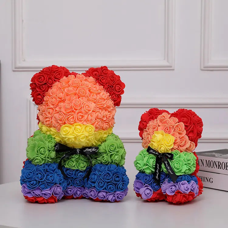 Two teddy bears made of colorful roses, featuring red, orange, yellow, green, and blue hues.