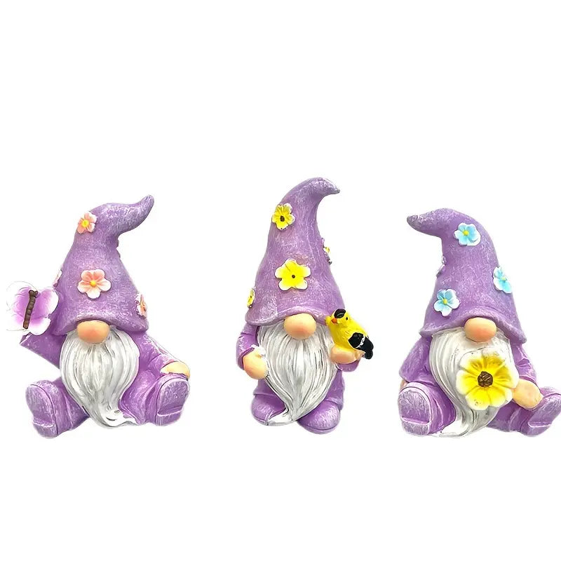 Three gnomes in purple hats with flowers, holding a butterfly, bee, and sunflower.